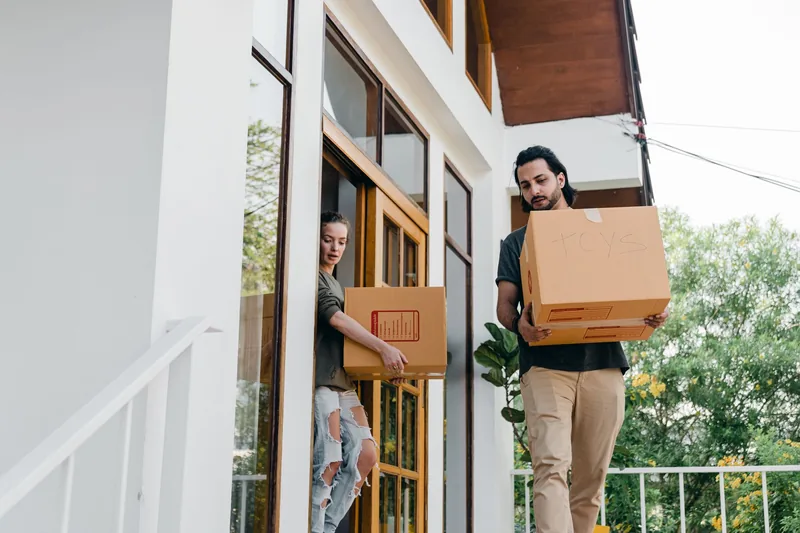 Someone carrying a box through a doorway