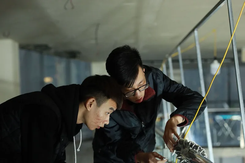 Two engineers working on fiber cabling